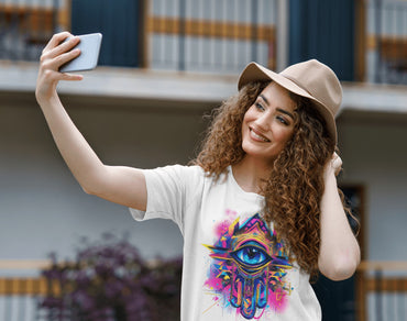 Woman taking a selfie in a white hamsa hand and evil eye Arabic graphic tee