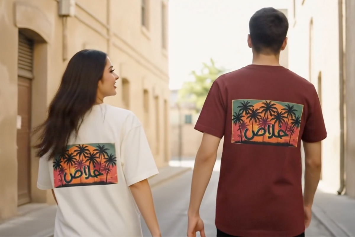 Couple wearing the Khalas Arabic palm tree sunset tee in white and maroon by Cairo NYC