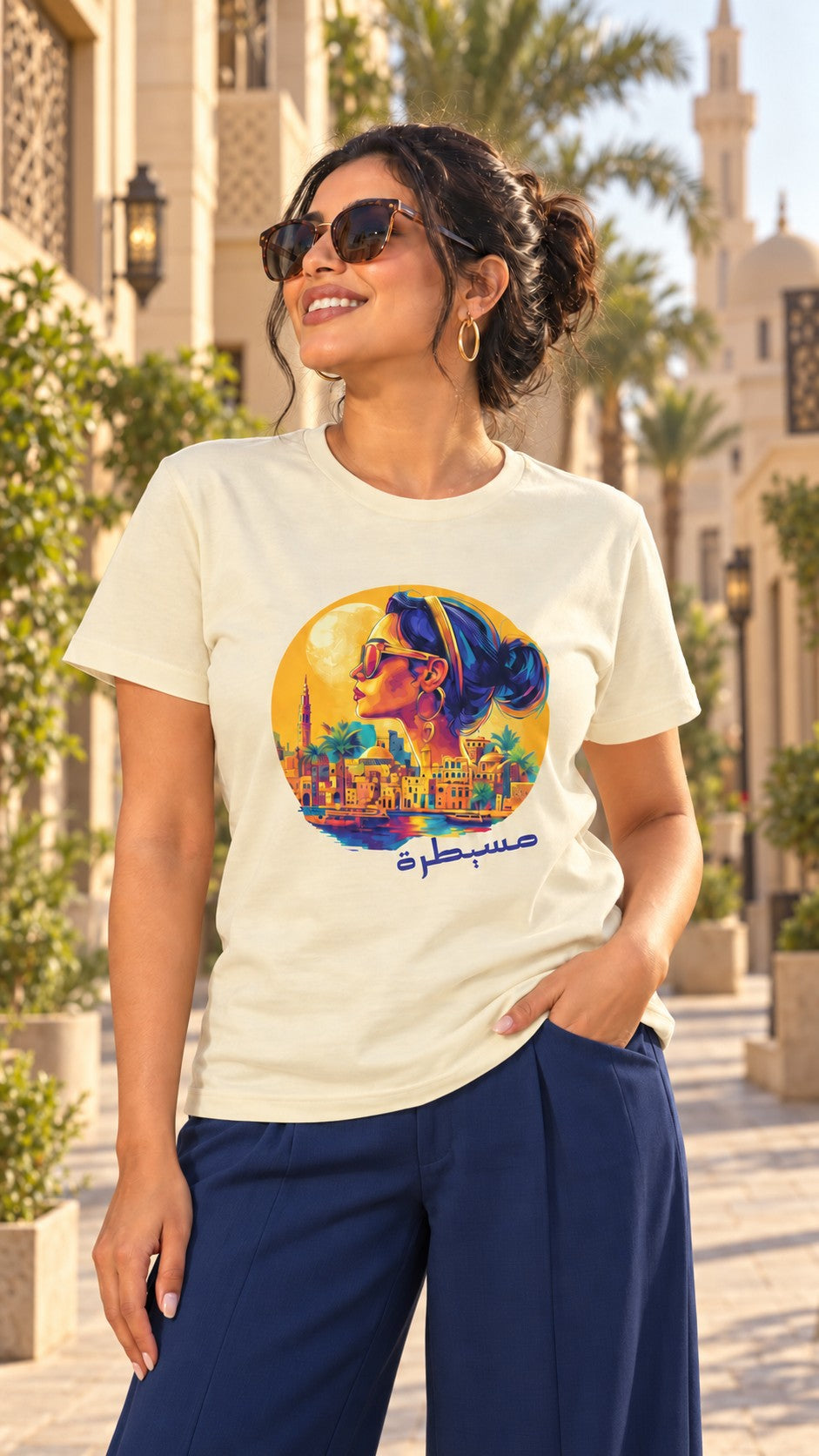 Woman in a cream مسيطرة Egyptian sunset diva Arabic tee and navy wide-leg pants on a palm-lined street