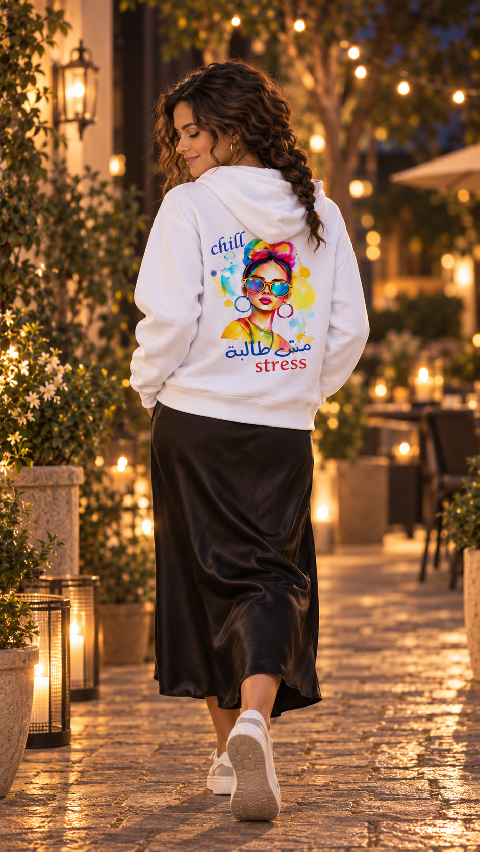 White Chill مش طالبة stress Arabic hoodie styled with a black satin midi skirt and white sneakers